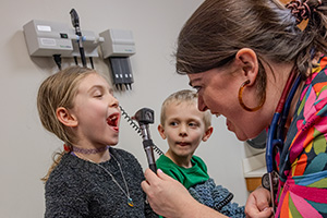 Two children, a boy and a girl, being treated in the pulmonology clinic at Le Bonheur Children's Hospital